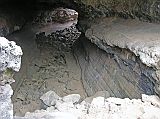 Galapagos 5-2-06 Santa Cruz Highlands Lava Tunnel As we got back to the outskirts of Puerto Ayora, we stopped at a lava tube called the Tunnel of Endless Love, named for the heart shaped hole in the roof. The tunnel is 800m long. Lava tubes are underground tunnels formed by huge lava flows whose exterior cooled and hardened, while the interior kept flowing, leaving tunnels.